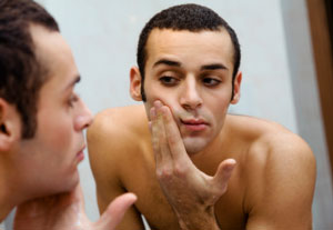 Man Checking for Pimples If you have diabetes, talk to your doctor about how alpha lipoic acid may help control blood sugar levels.